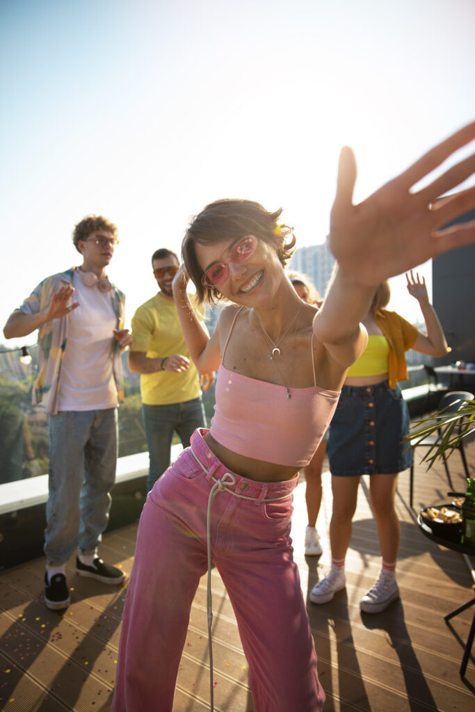 front-view-smiley-woman-dancing-outdoors